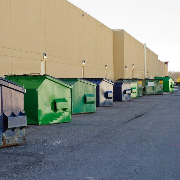 closed commercial dumpster with a no dumping sign attached